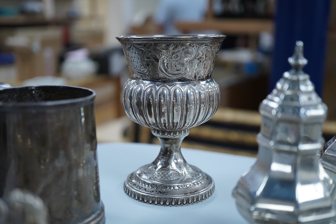 A collection of small silver wares to include a George V silver porringer, two George V silver sauce boats, a let Victorian silver sugar bowl, a George III silver goblet, with later embossed decoration, a George V small